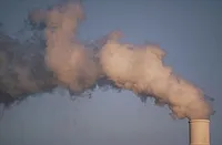 Air pollution smoke rising from plant tower