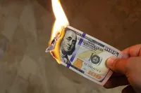 $100 bill on fire