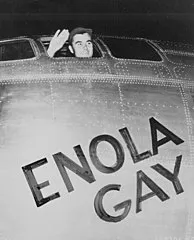 Colonel Paul Tibbets, pilot of the Enola Gay, waving from its cockpit