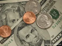 Picture of American paper money with coins on top