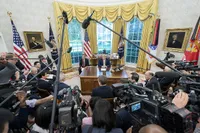 Trump in the Oval Office surrounded by press (2019)