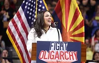 Alexandria Ocasio-Cortez speaking to a crowd in Arizona at a 'Fight Oligarchy' rally