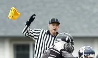 Penalty flag thrown by football referee blowing a whistle