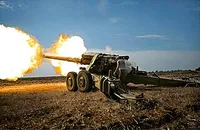 Towed howitzer firing a shell in eastern Ukraine