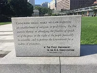 Stone monument engraved with the First Amendment, reading 'Congress shall make no law repsepcting an establishment of religion, or prohibiting the free exercise thereof; or abridging the freedom of speech, or of the press; or the right of the people peaceably to assemble, and to petition the Government for a redress of grievances. The First Amendment to the U.S. Constitutiotn, 15 December 1791.