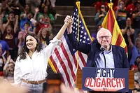Alexandria Ocasio-Cortez and Bernie Sanders on stage during a 'Fight Oligarchy' rally in 2025