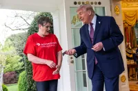 Trump awkwardly hands a DoorDash driver a $100 tip in a cheesy political stunt at the White House earlier this year