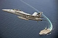 F-A-18 Super Horned flying over the USS Gerald Ford