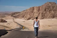Woman walking a desert road