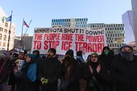 protestors holding sign reading 'Minnesota shut it down! The people have the power to stop ICE terror!'